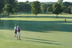 Old and young golfers